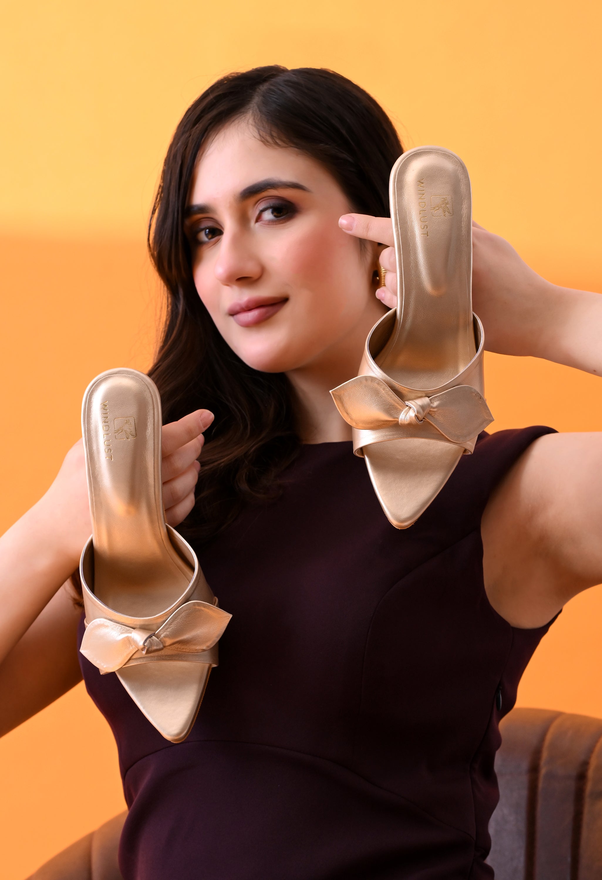 Handmade Aura Gold kitten heels with bow detail from Windlust, showcasing elegant design and gold finish.