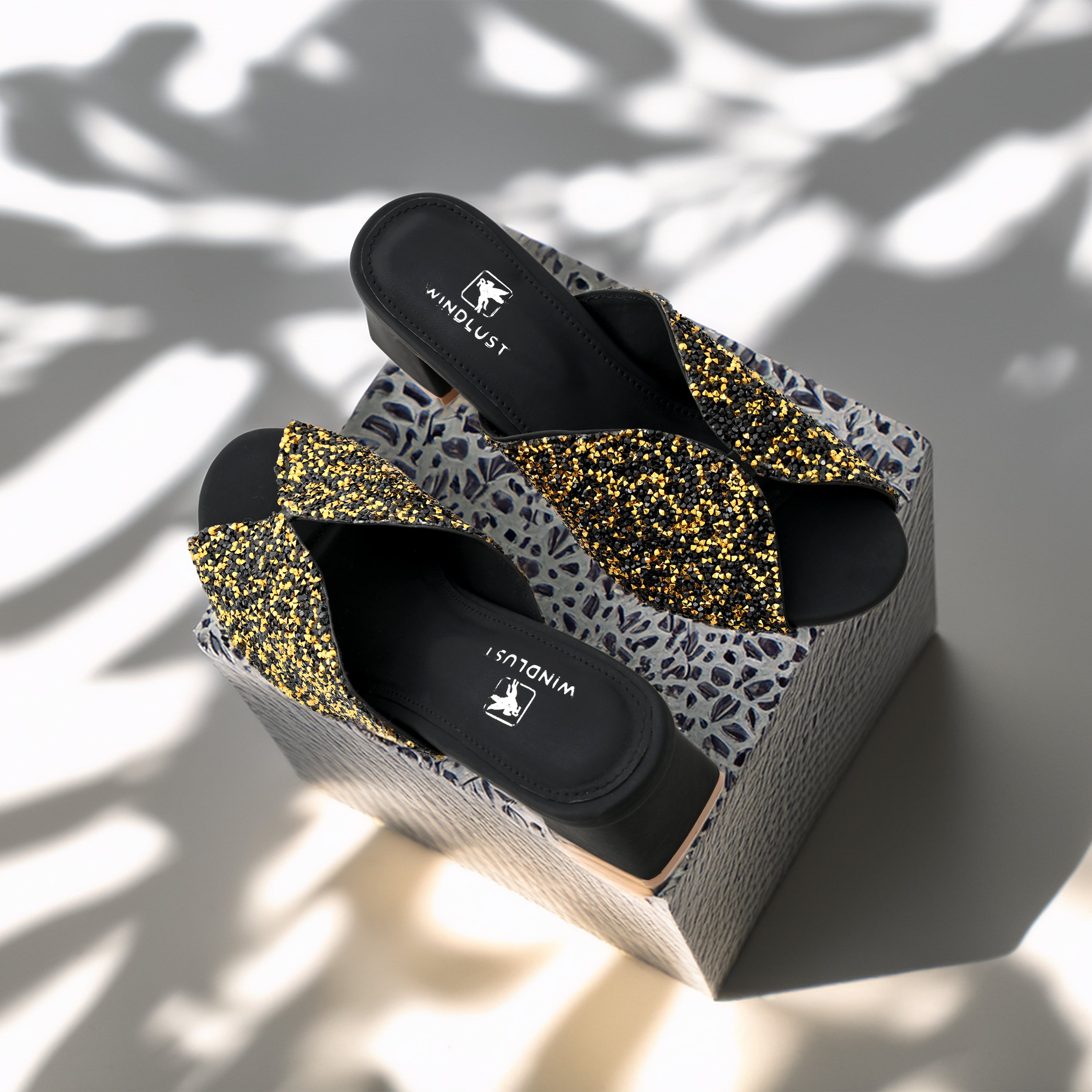 Gold and black Swarovski Block Heels by Windlust with shimmering crystal embellishments and a sturdy block heel design.