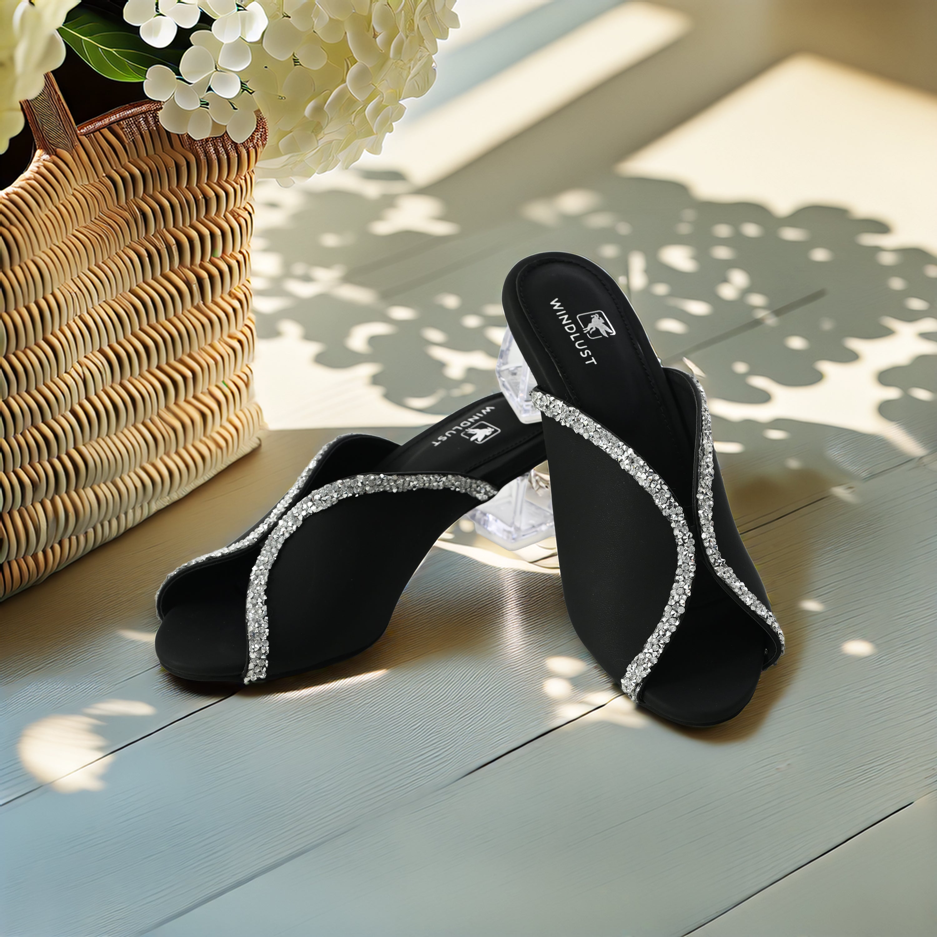 Black Swarovski-embellished Windlust heel with a hollow heel design, showcasing elegant craftsmanship and sparkling details.