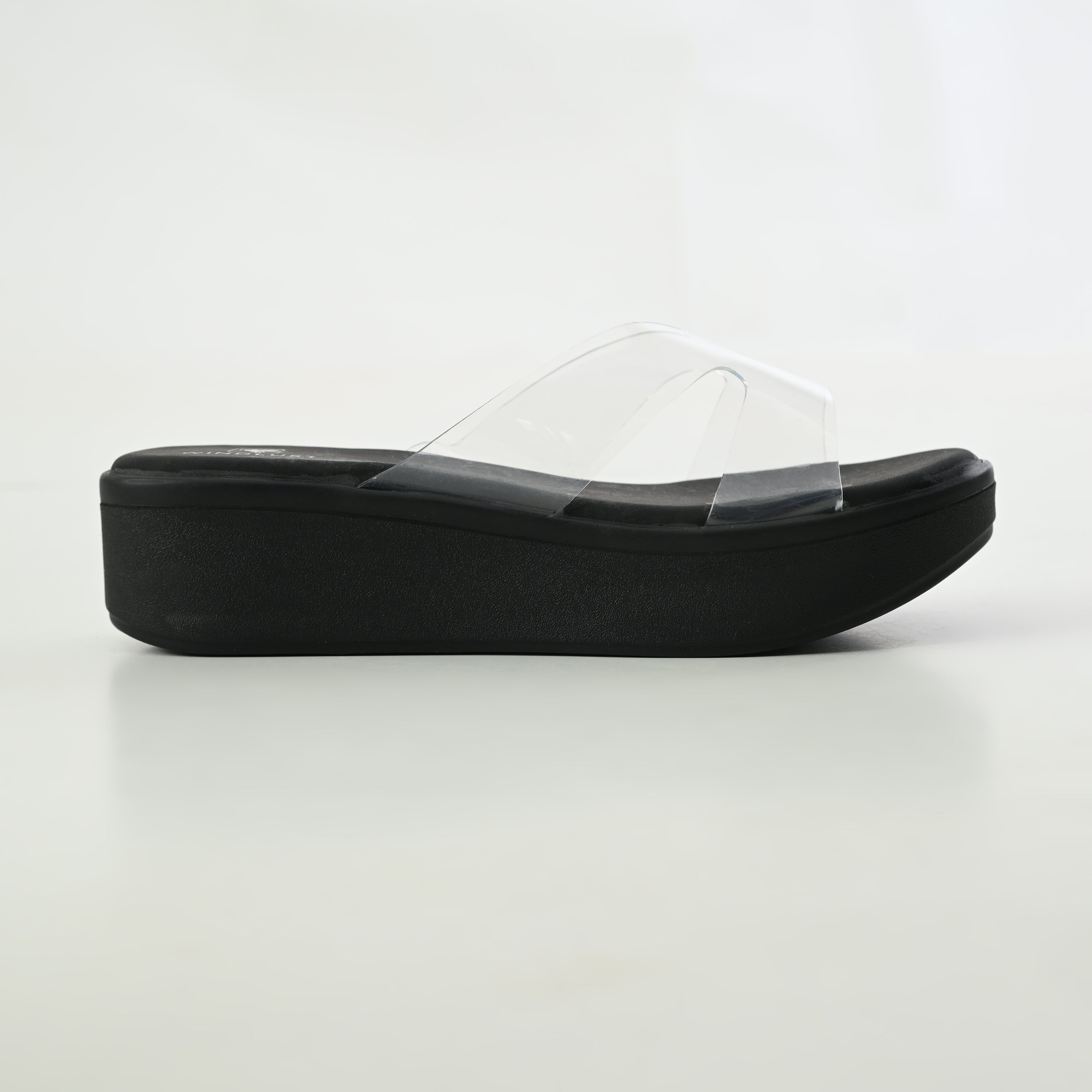 Black CLEAR X-FLOW Wedge by Windlust, showcasing a stylish and comfortable wedge shoe with a clear design and sturdy heel.