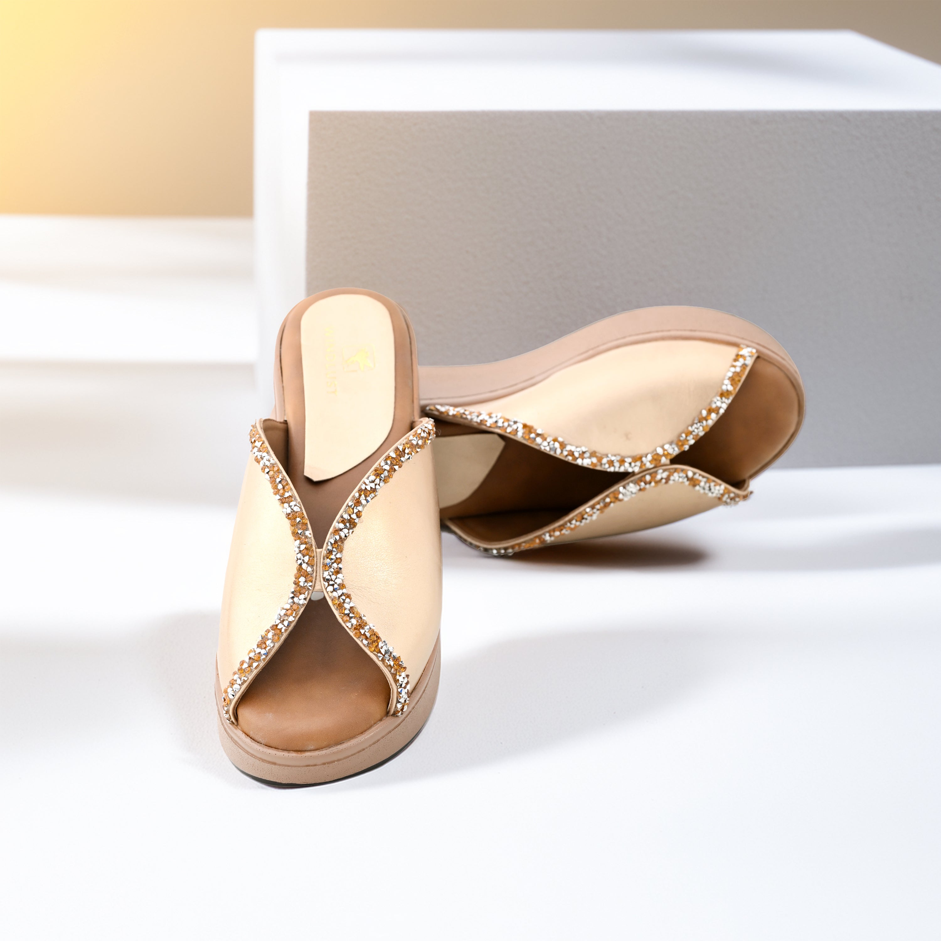 Windlust duo-tone Swarovski detailed wedges in matte gold featuring intricate embellishments and stylish design.