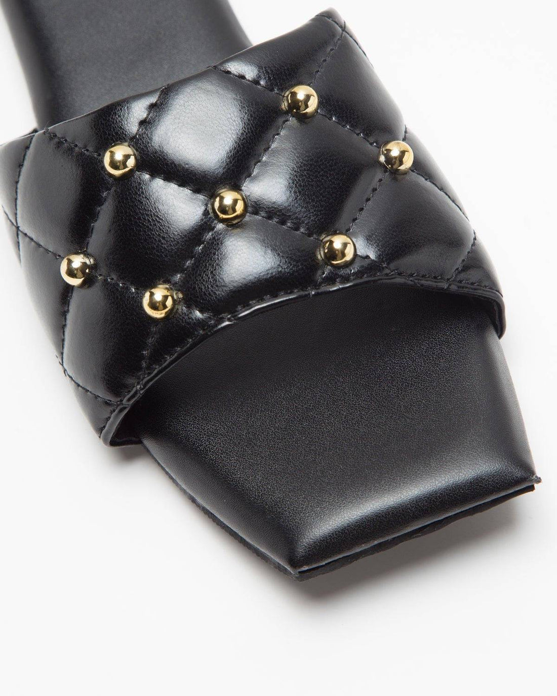 Black Windlust T-shaped flats with studded design, featuring a sleek silhouette and comfortable flat sole.