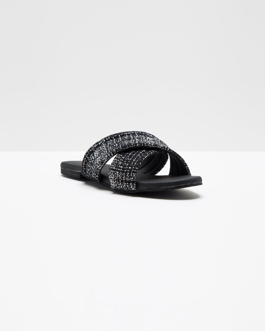 Black cross-strap jute flats by Windlust featuring a comfortable slip-on design and natural woven jute material.