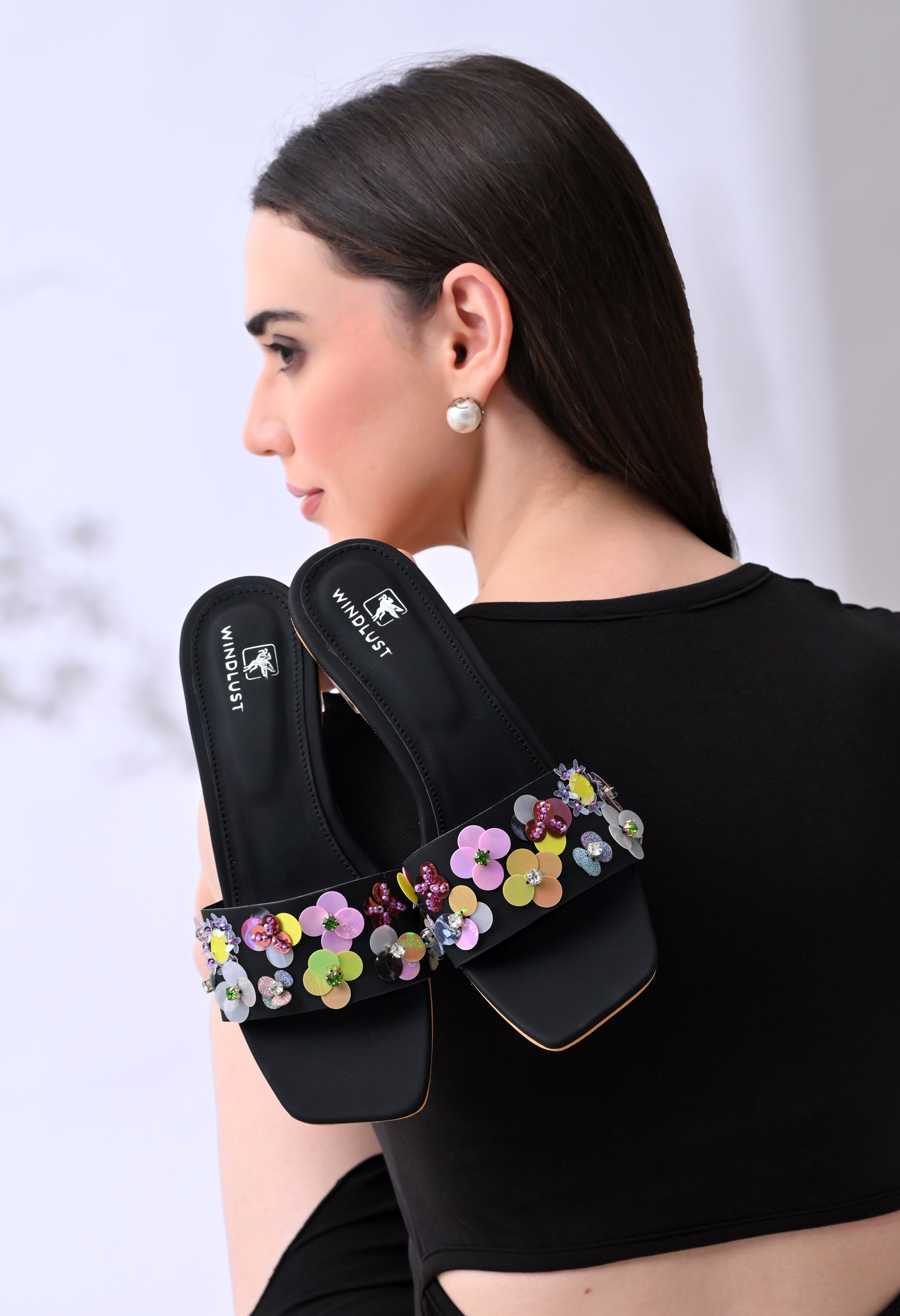 Black hand-embellished luxury heels by Windlust with intricate detailing, stylish and elegant footwear for formal occasions.
