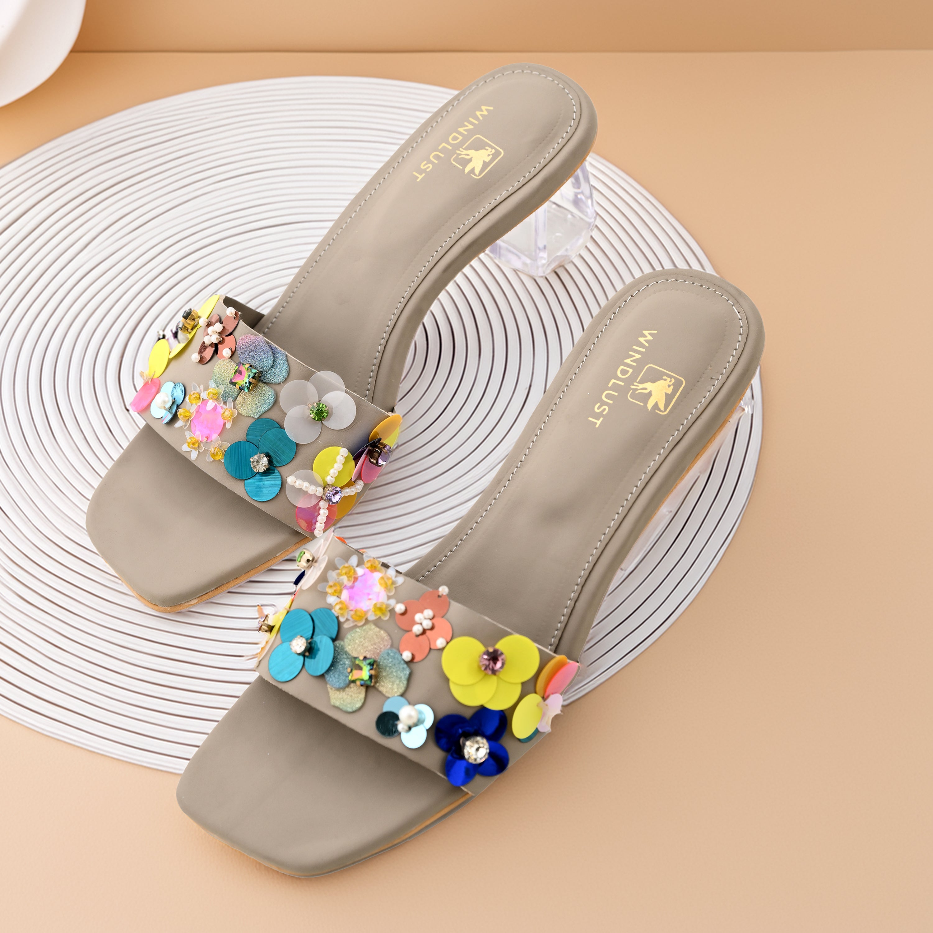 Hand-embellished taupe luxury heels by Windlust, featuring intricate detailing and elegant design, photographed from the side.