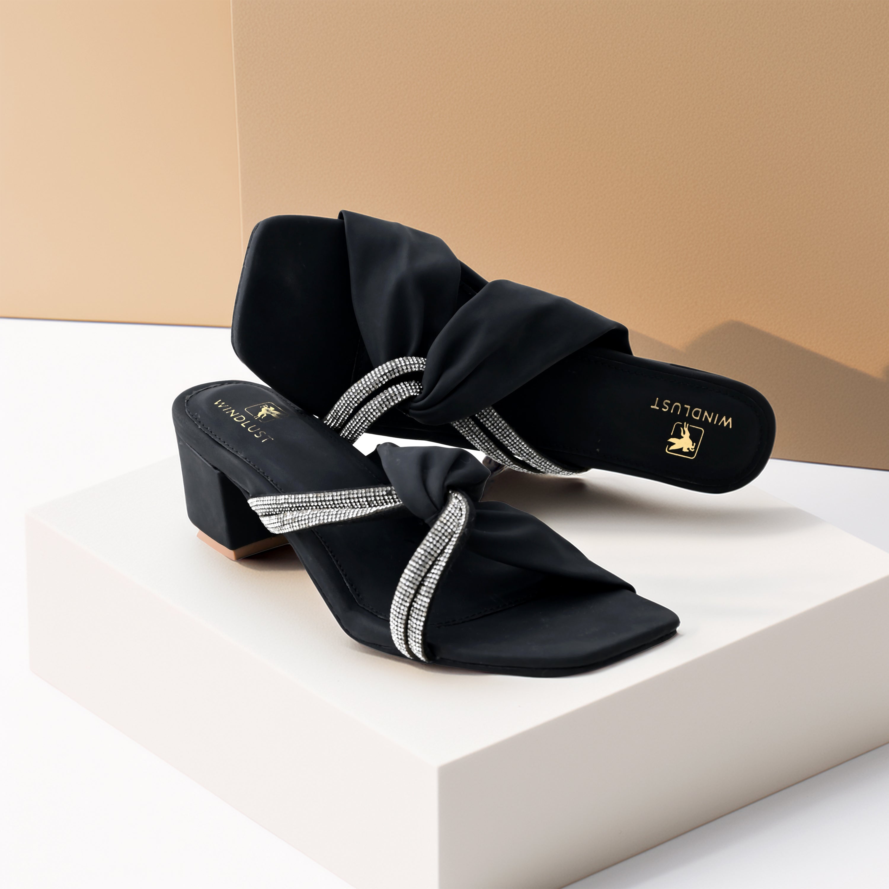 Black Windlust interlocked Swarovski string heels with elegant design and sparkling embellishments, showcasing the stylish footwear.