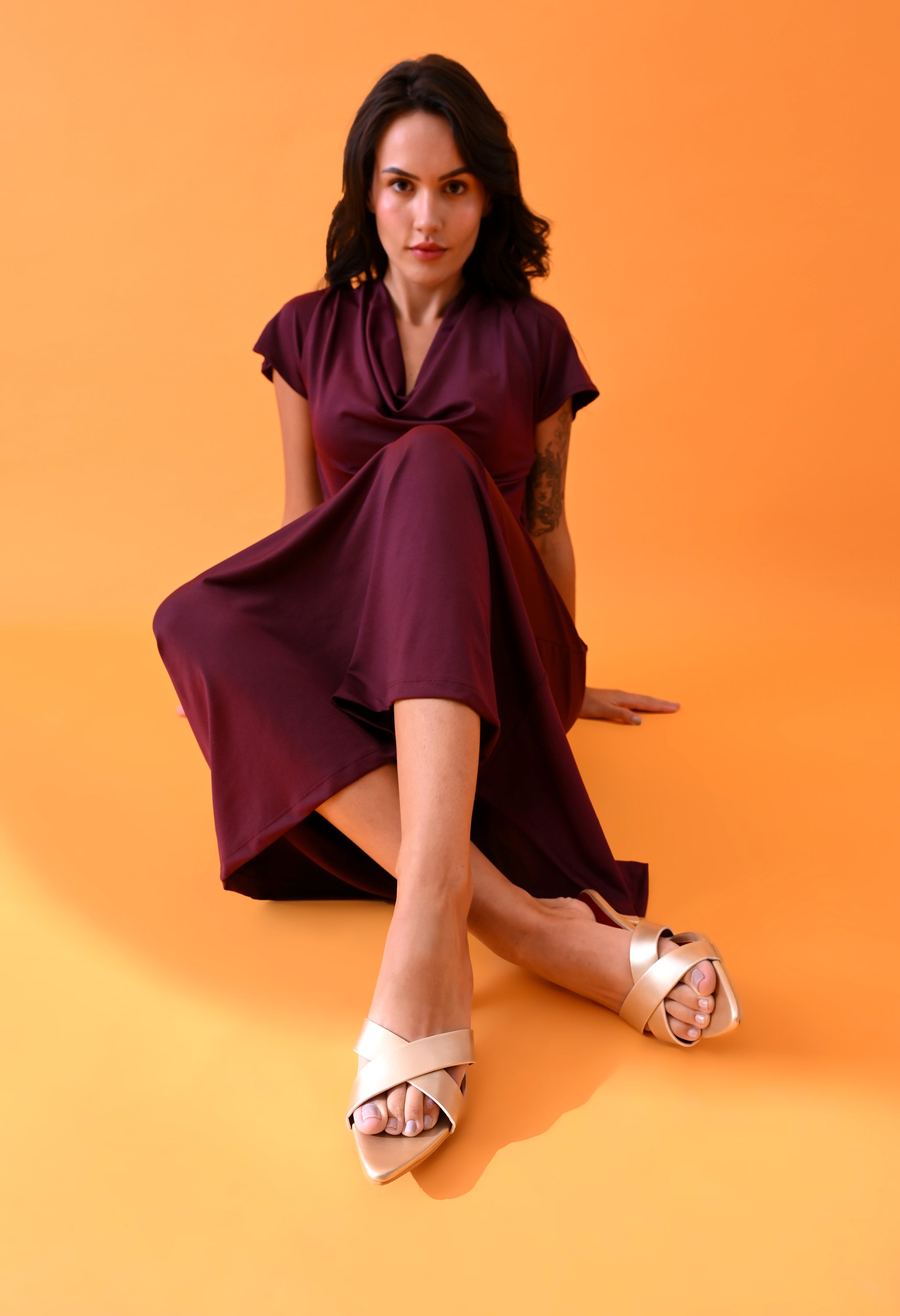 Gold cross-strapped kitten heels by Windlust, showcasing elegant design and sleek style in a close-up view.