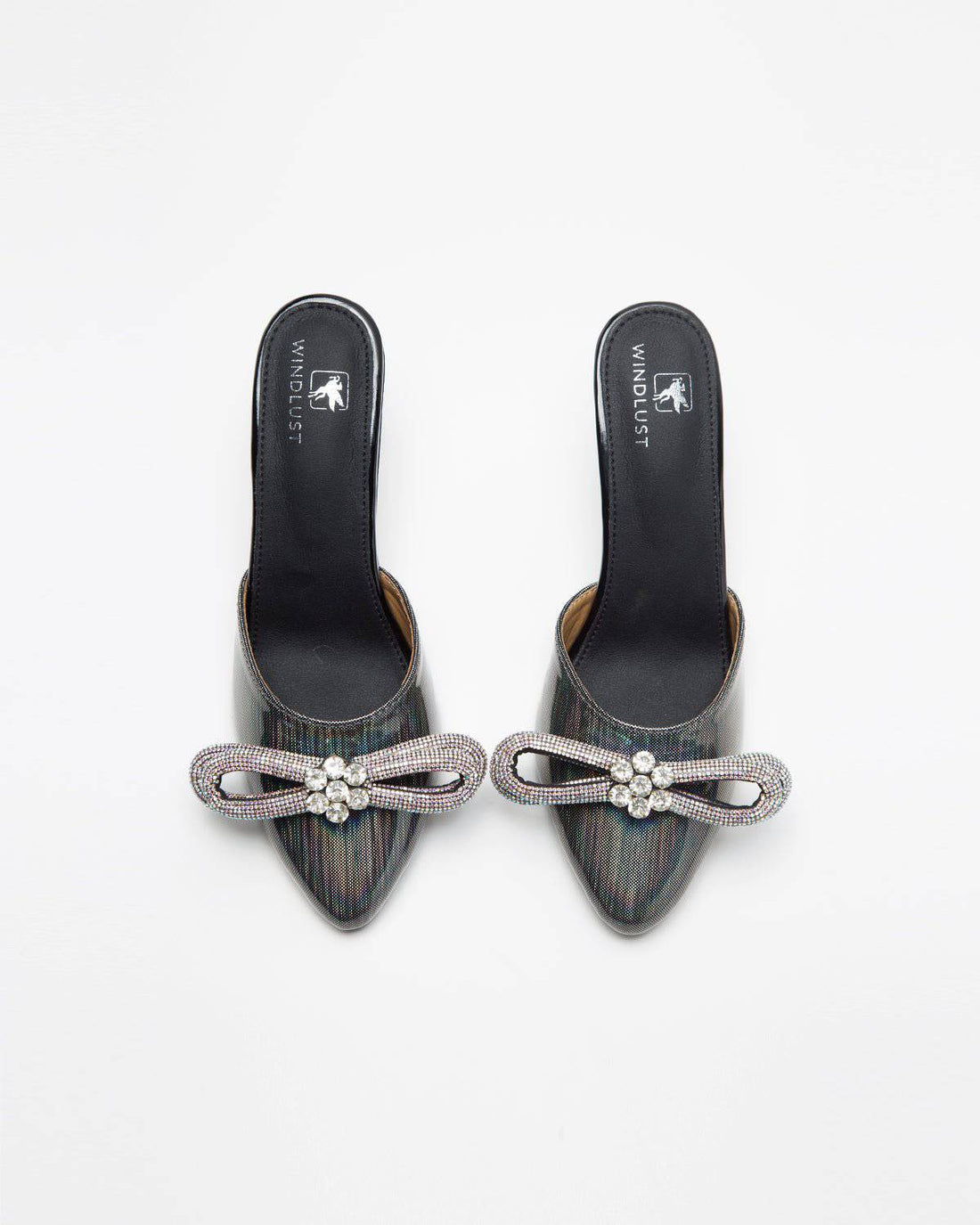 Metallic grey embellished bow heels by Windlust, featuring a stylish design with decorative details and a sleek heel.