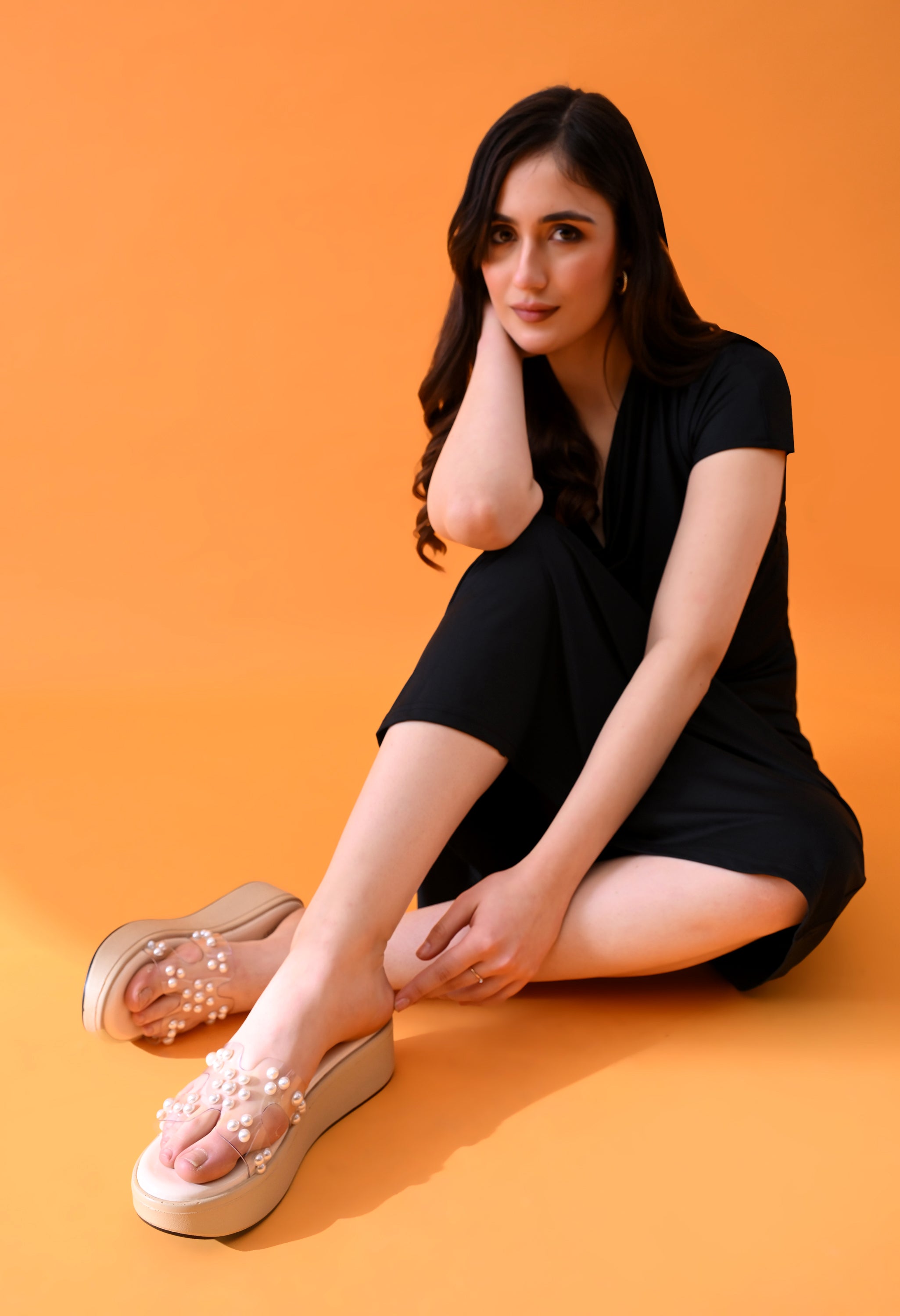 Windlust 4-way cut transparent pearl edition nude cream platform wedges shown from side angle.