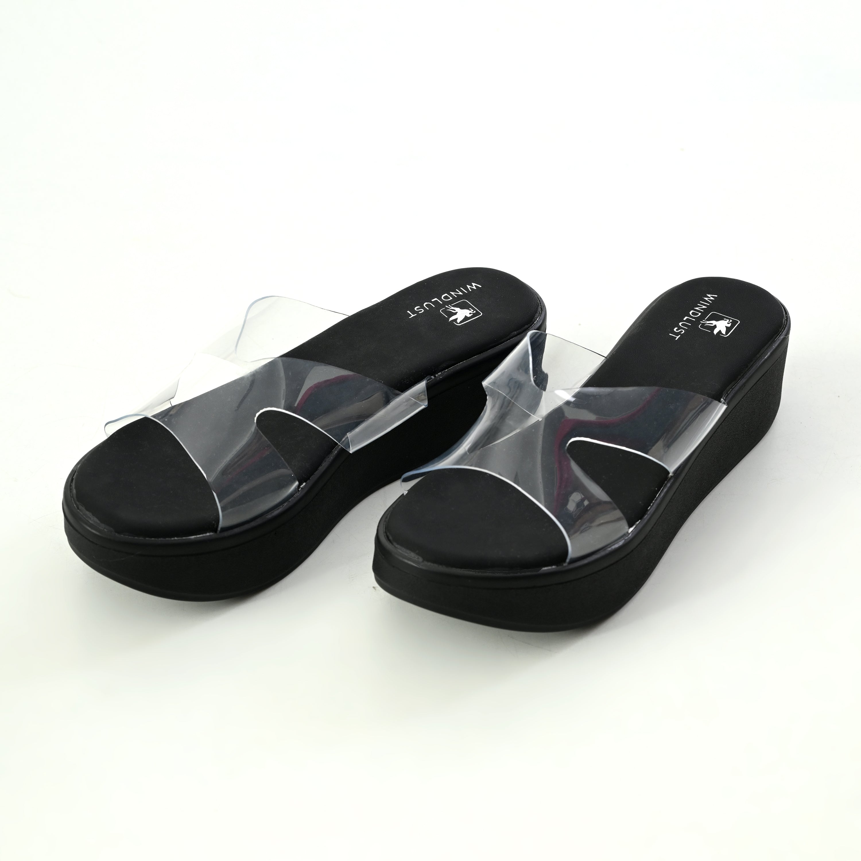 Black Windlust CLEAR X-FLOW wedge sandal with transparent design and sturdy heel on a white background.