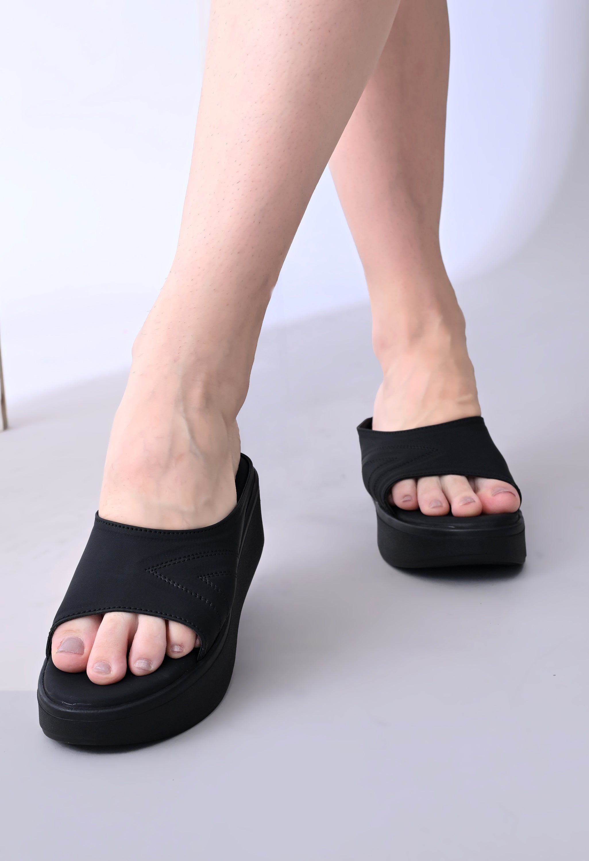 Windlust Luxè Sewed In Wedge in Dense Black showing the stylish, textured leather wedge shoe with a sleek design.