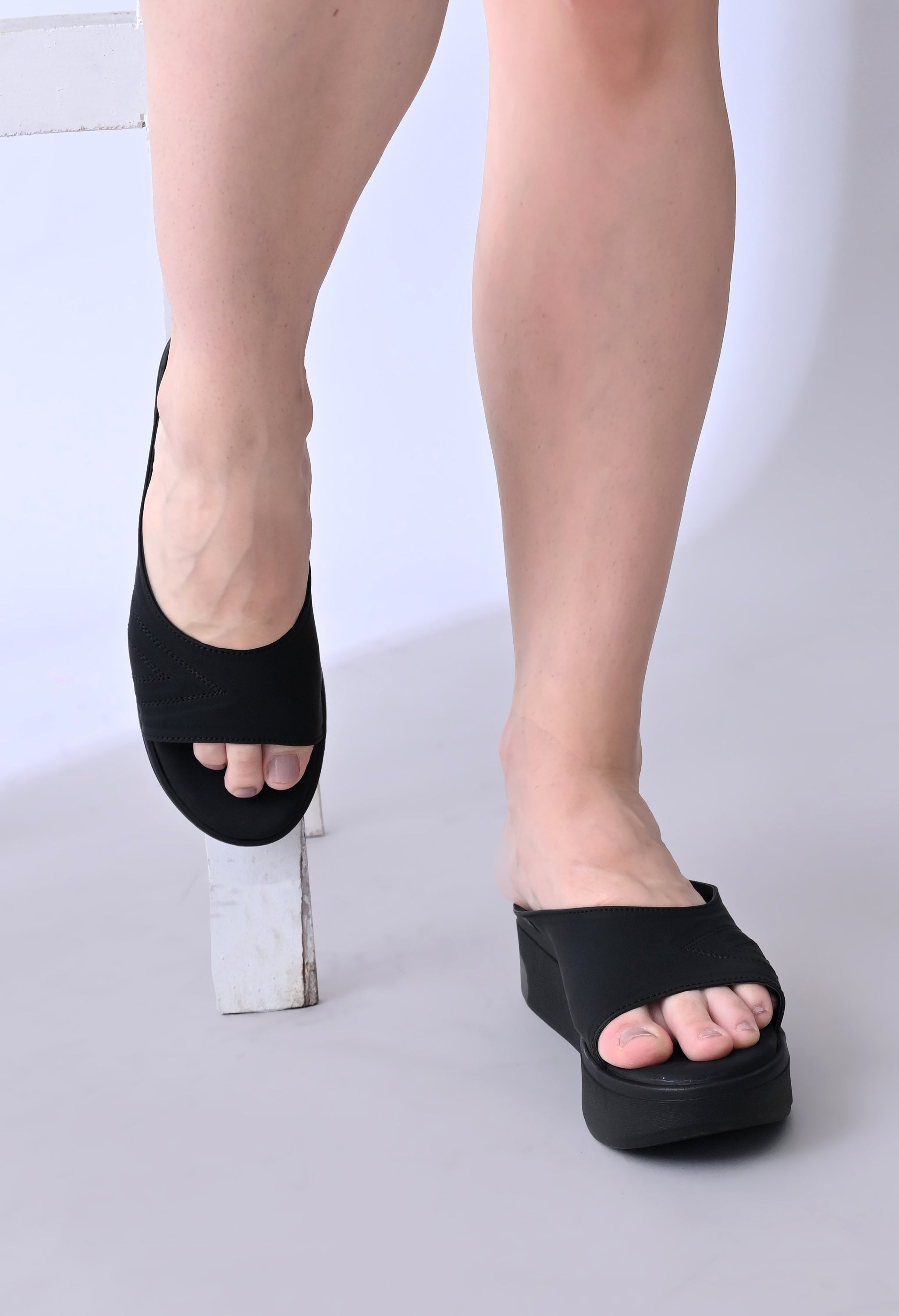 Windlust Luxè Sewed In Wedge in Dense Black, showcasing the stylish black wedge shoes with detailed sewing and sleek design.